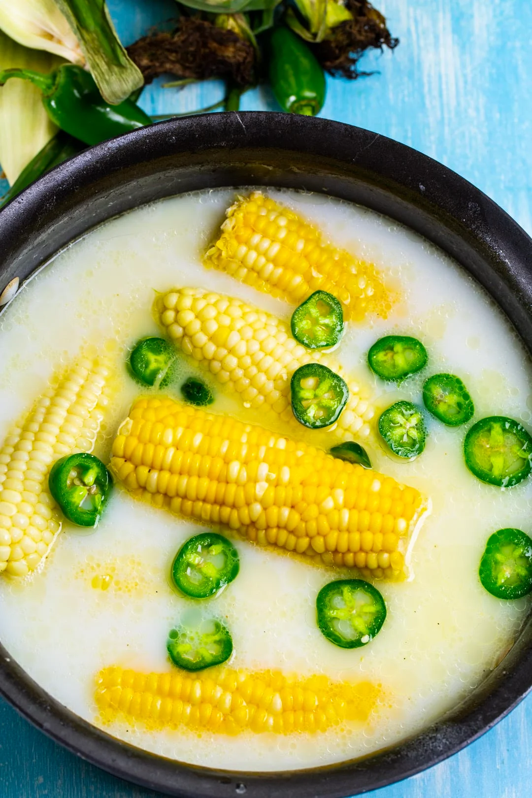 Corn and jalapeno slices in milk bath.