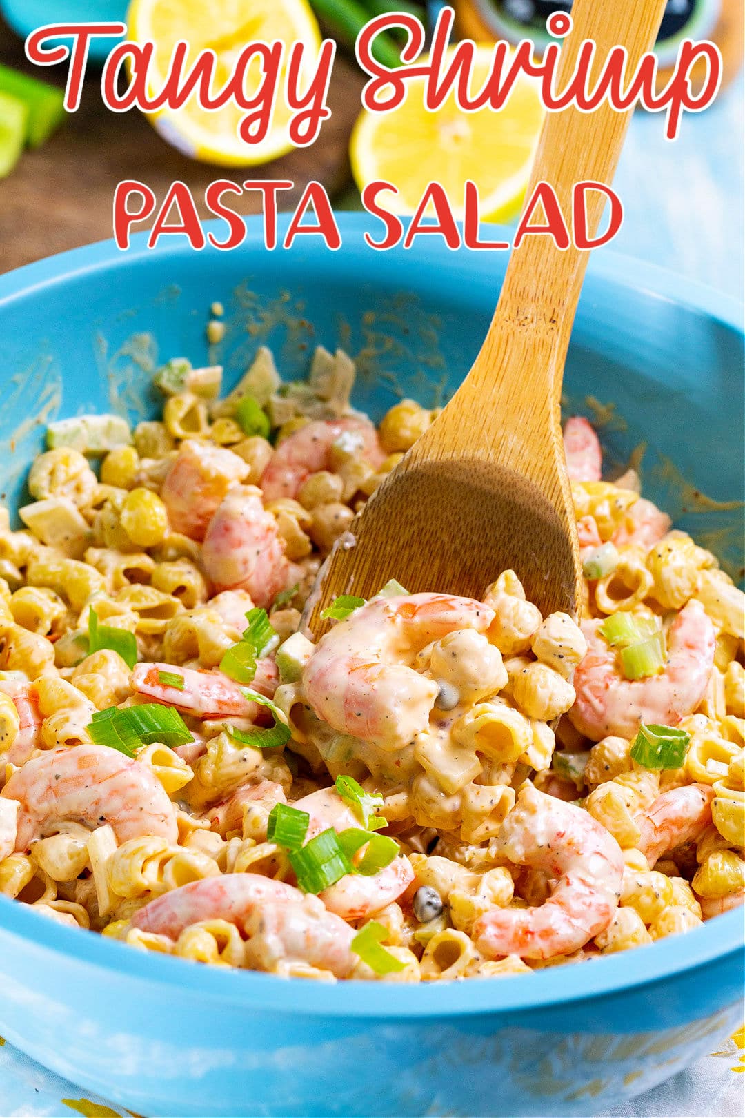 Wooden spoon scooping up pasta salad.