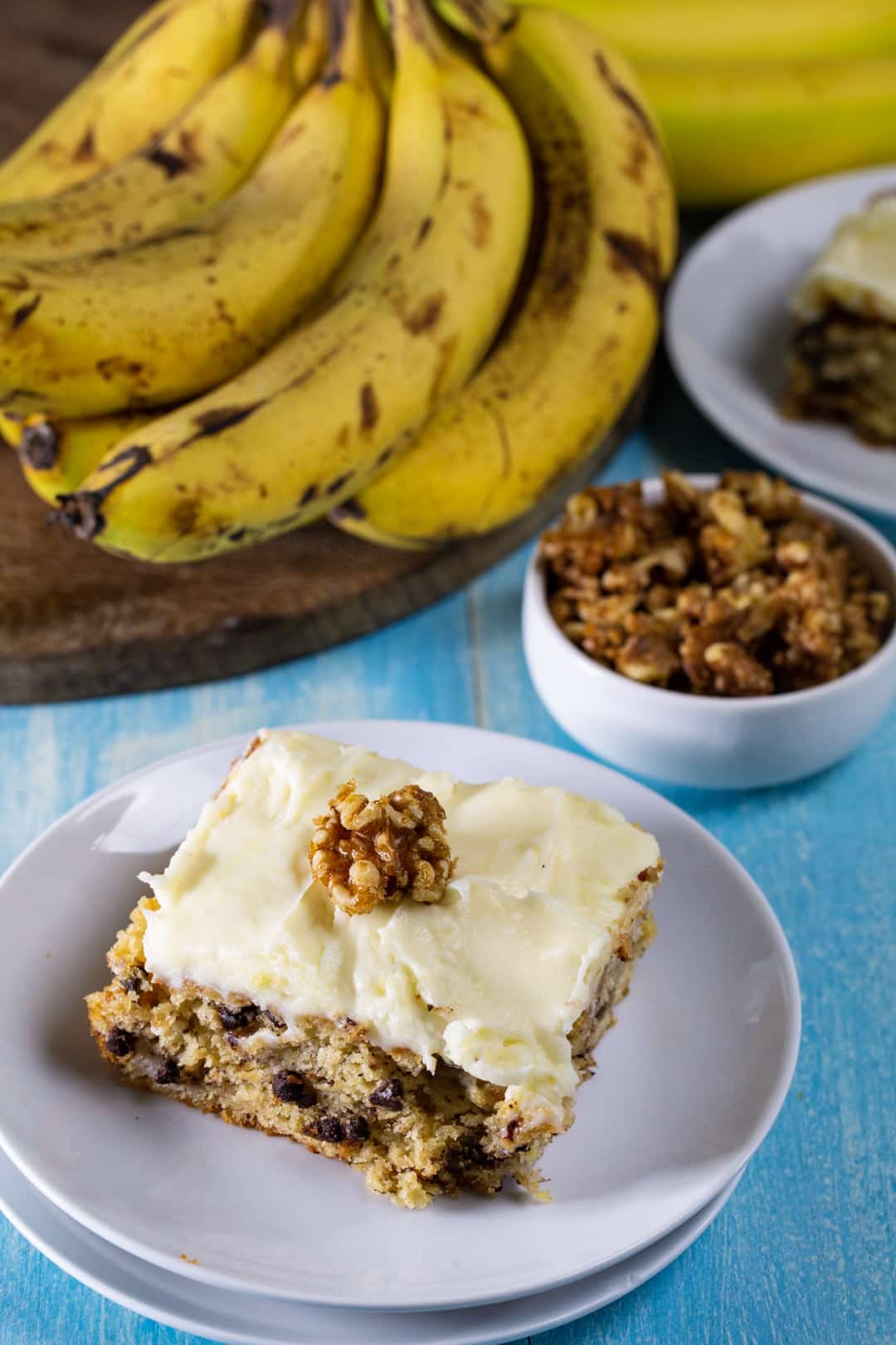 Banana Cake with Cream Cheese Frosting slice on a plate.