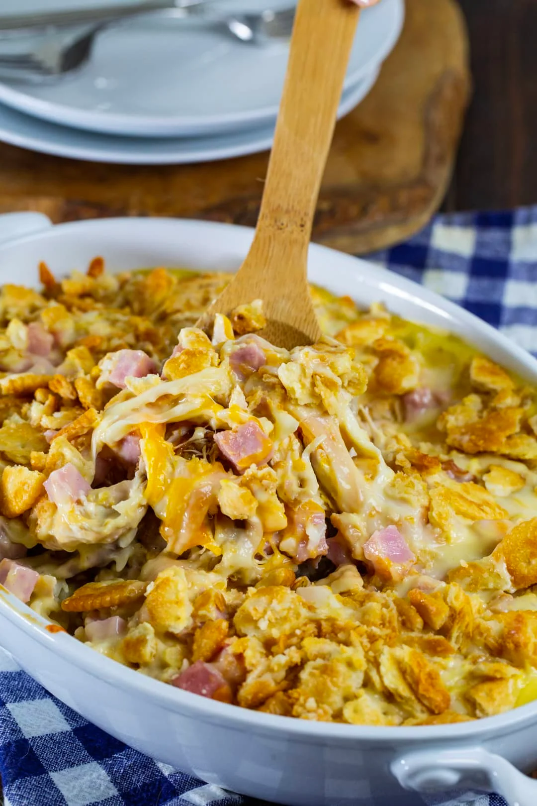 Wooden spoon scooping up casserole.