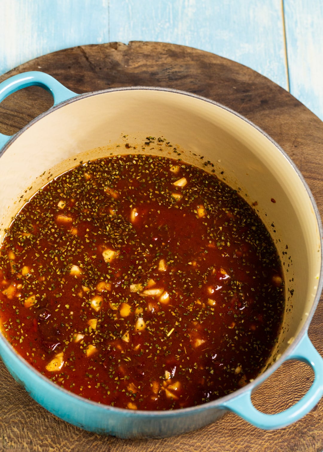 Ketchup and chipotle peppers mixed together in Dutch oven.