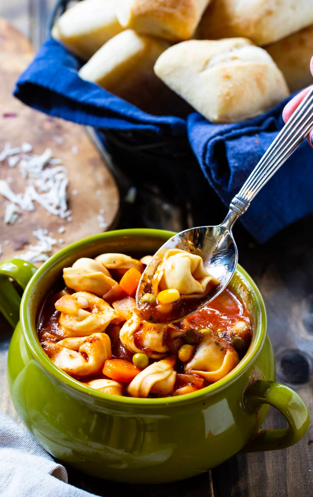 Spoon going into bowl of soup.