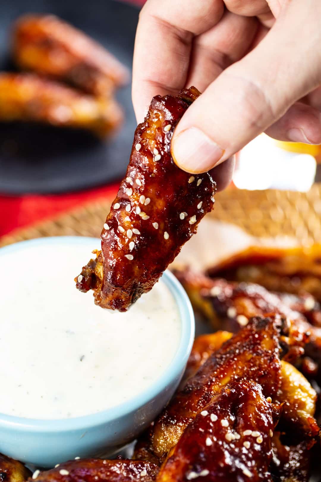 Hand dipping wing into ranch dressing.