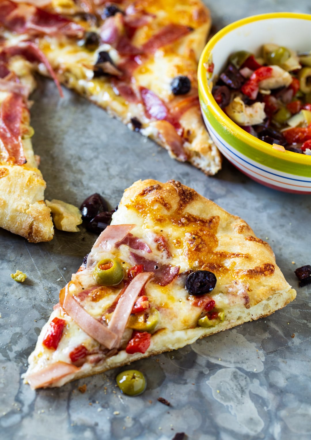 Slice of Muffaletta Pizza.