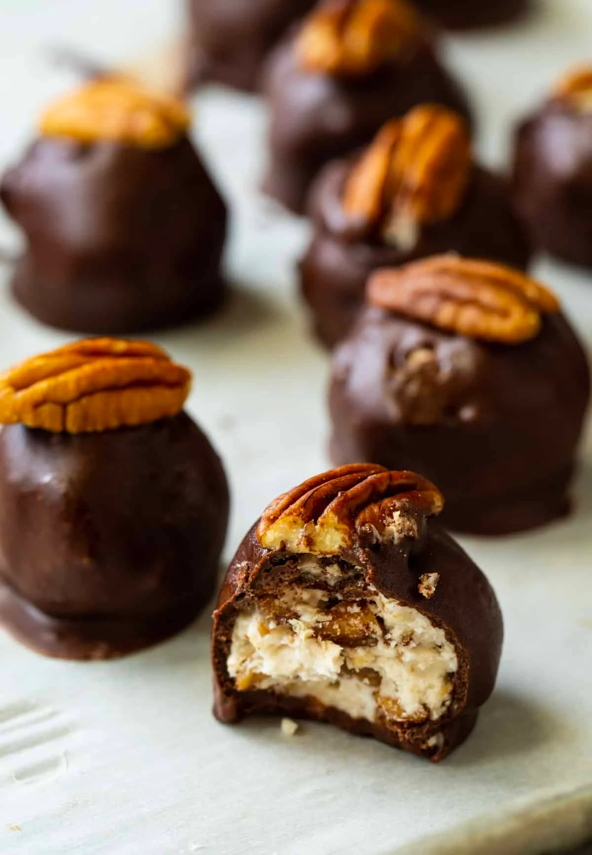 Bourbon Balls with bite taken out of one of them.