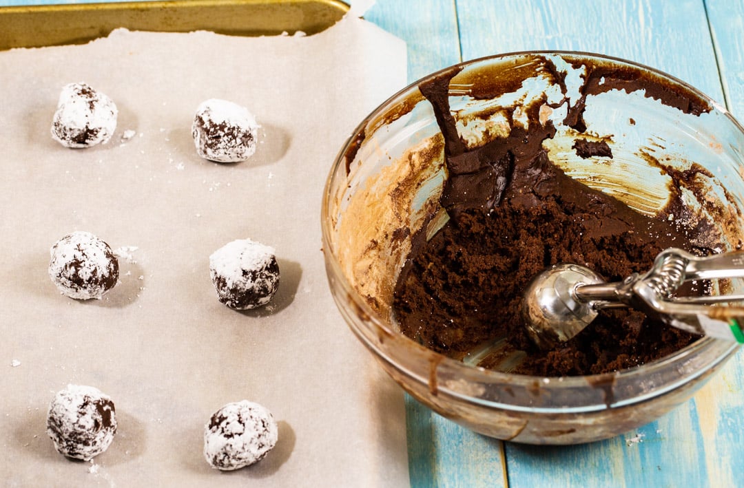 Cookie dough getting rolled into balls.