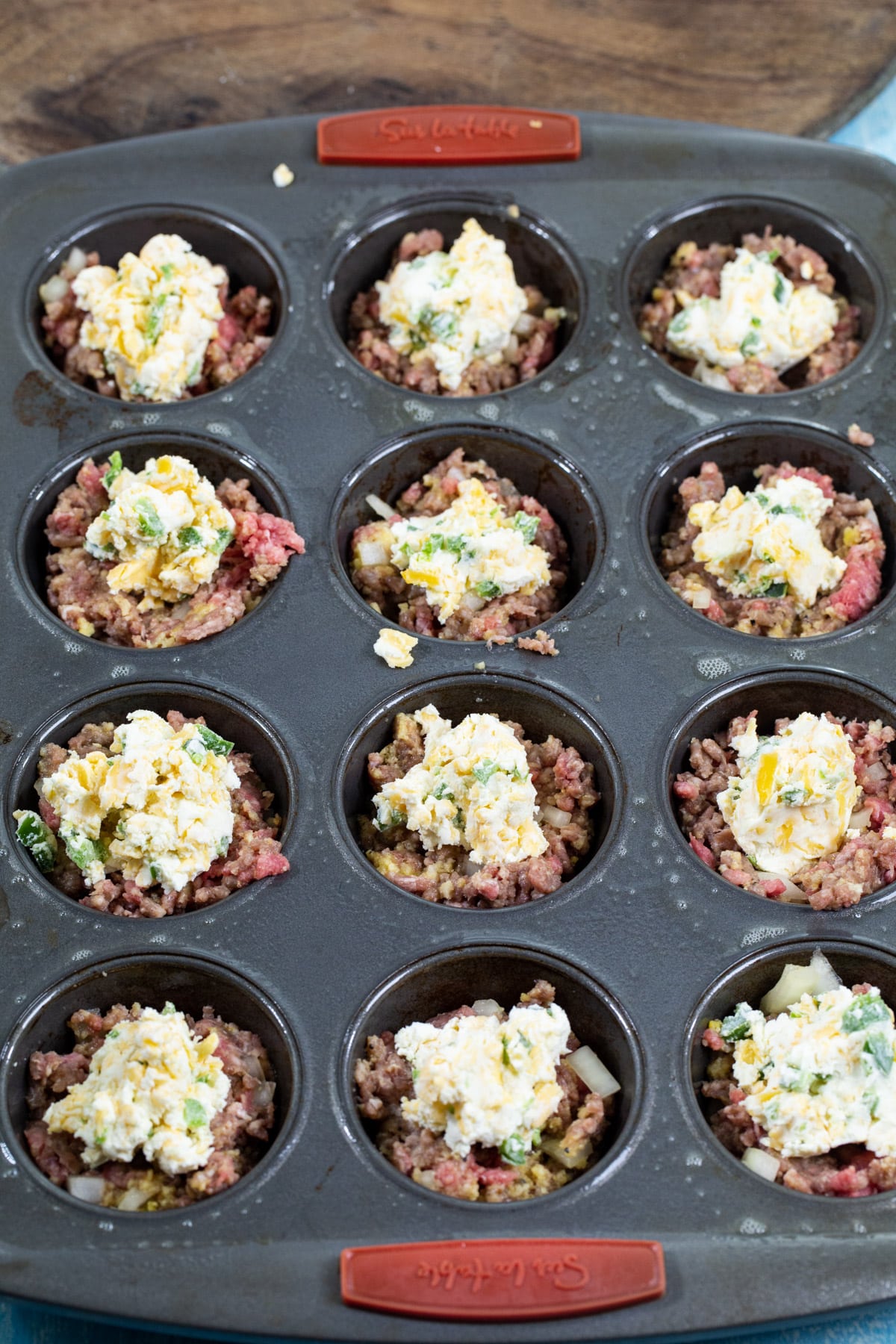 Cream cheese placed on top of ground beef mixture.