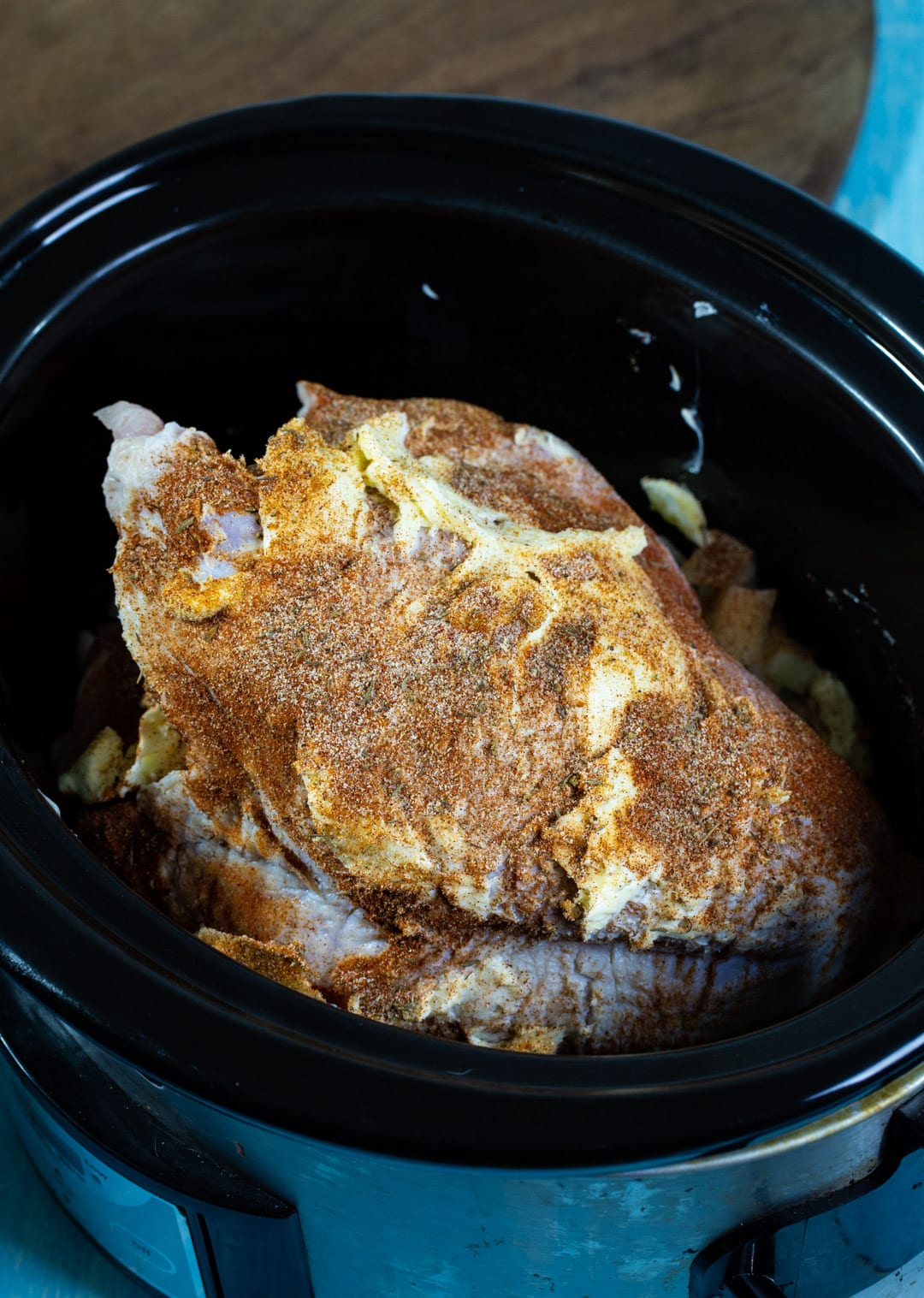 Oncooked turkey breast coated in rub.