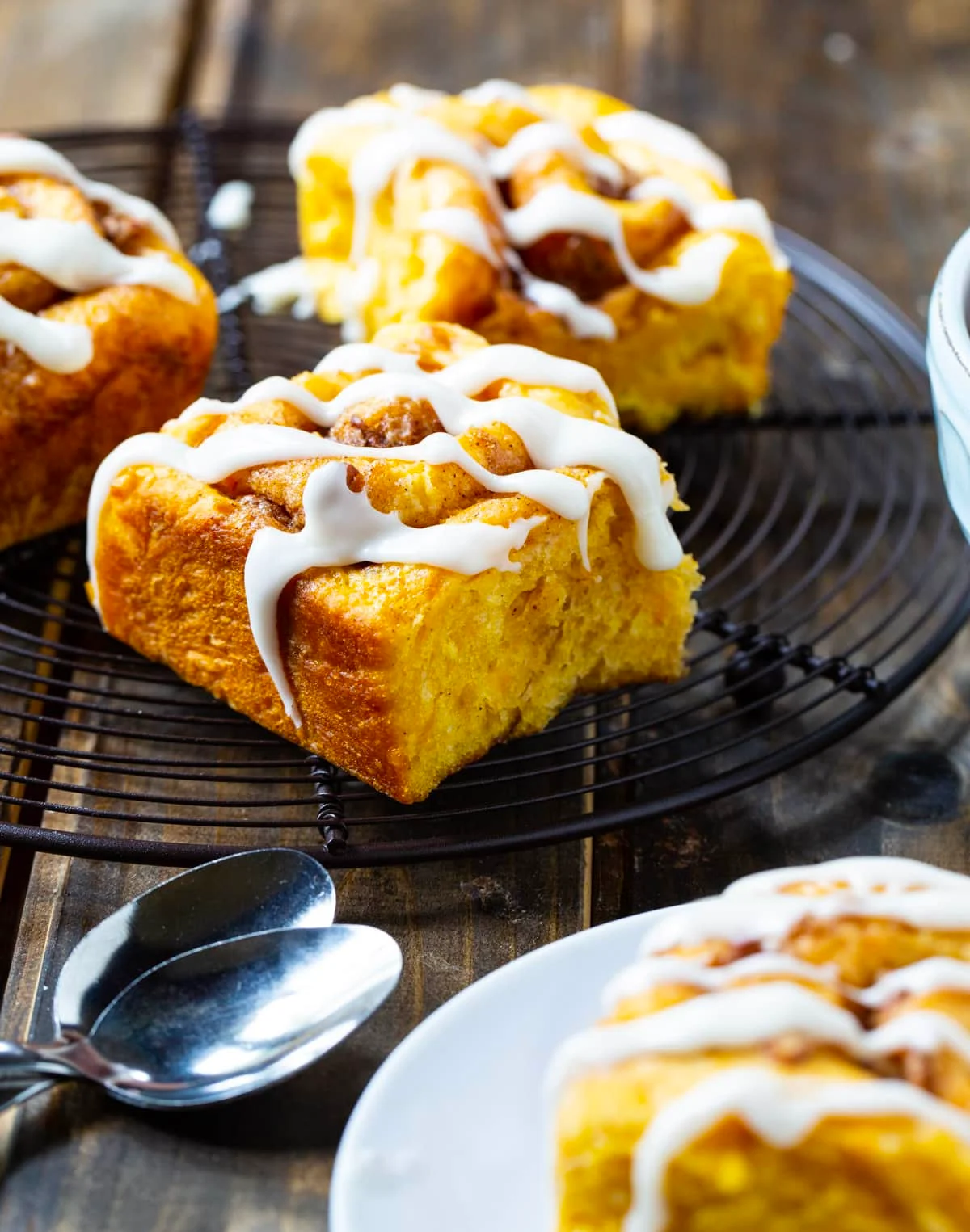 Cinnamon rolls on wire rack.
