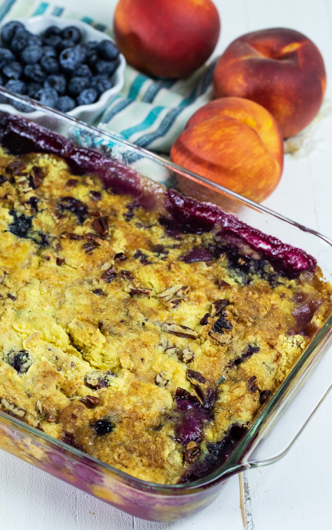 Dump Cake in baking dish and bowl full of blueberries.