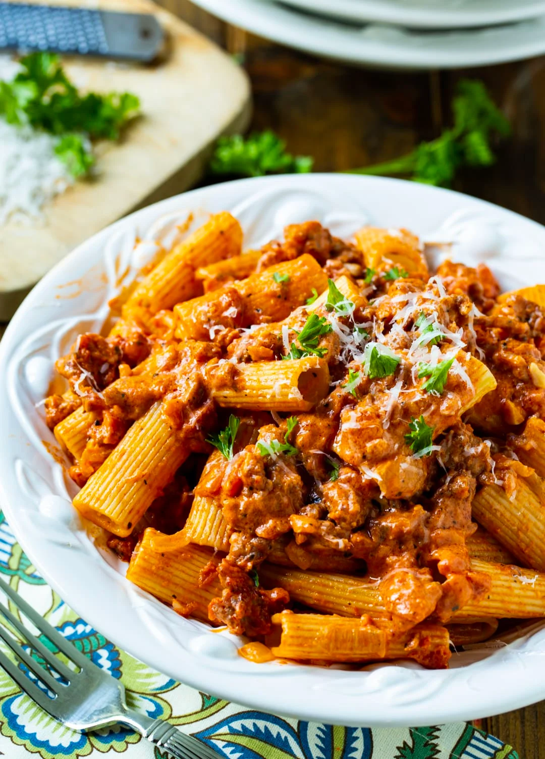 Pasta coated in sauce in serving bowl.