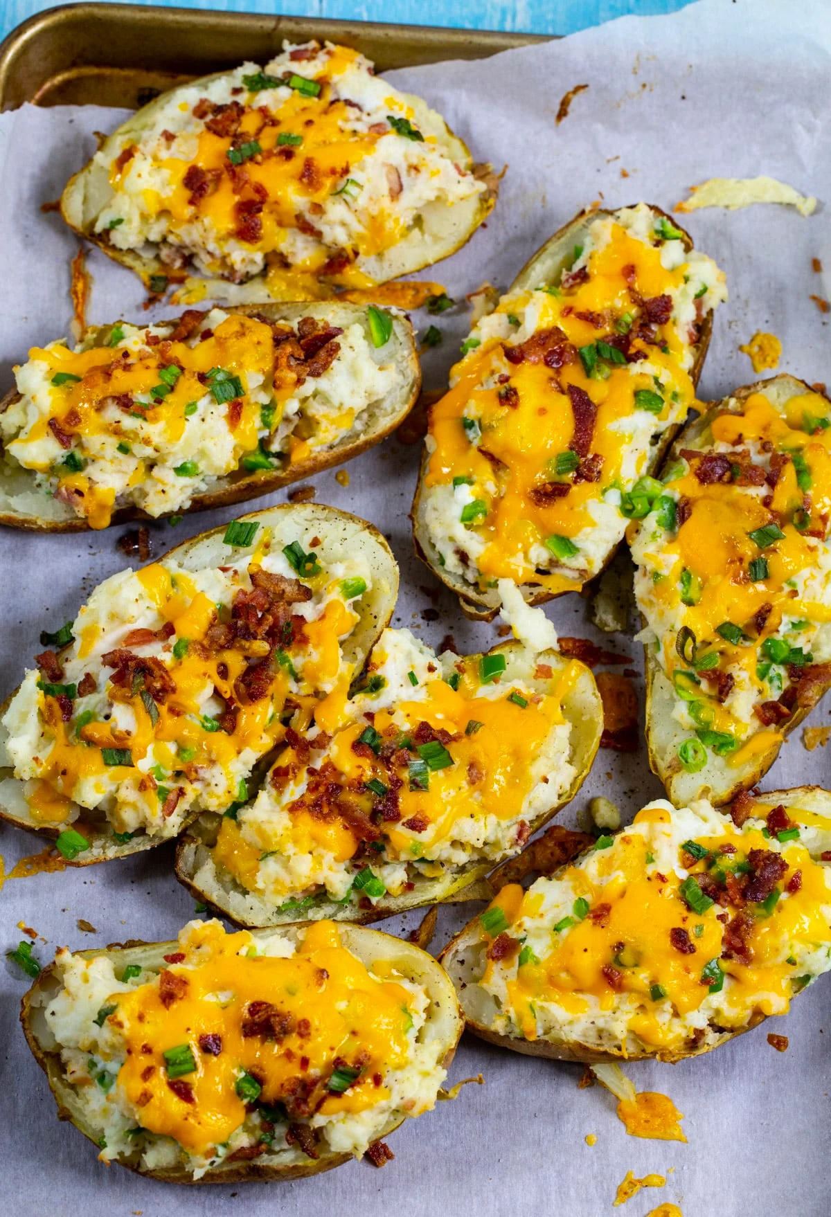 Stuffed potatoes on baking sheet.