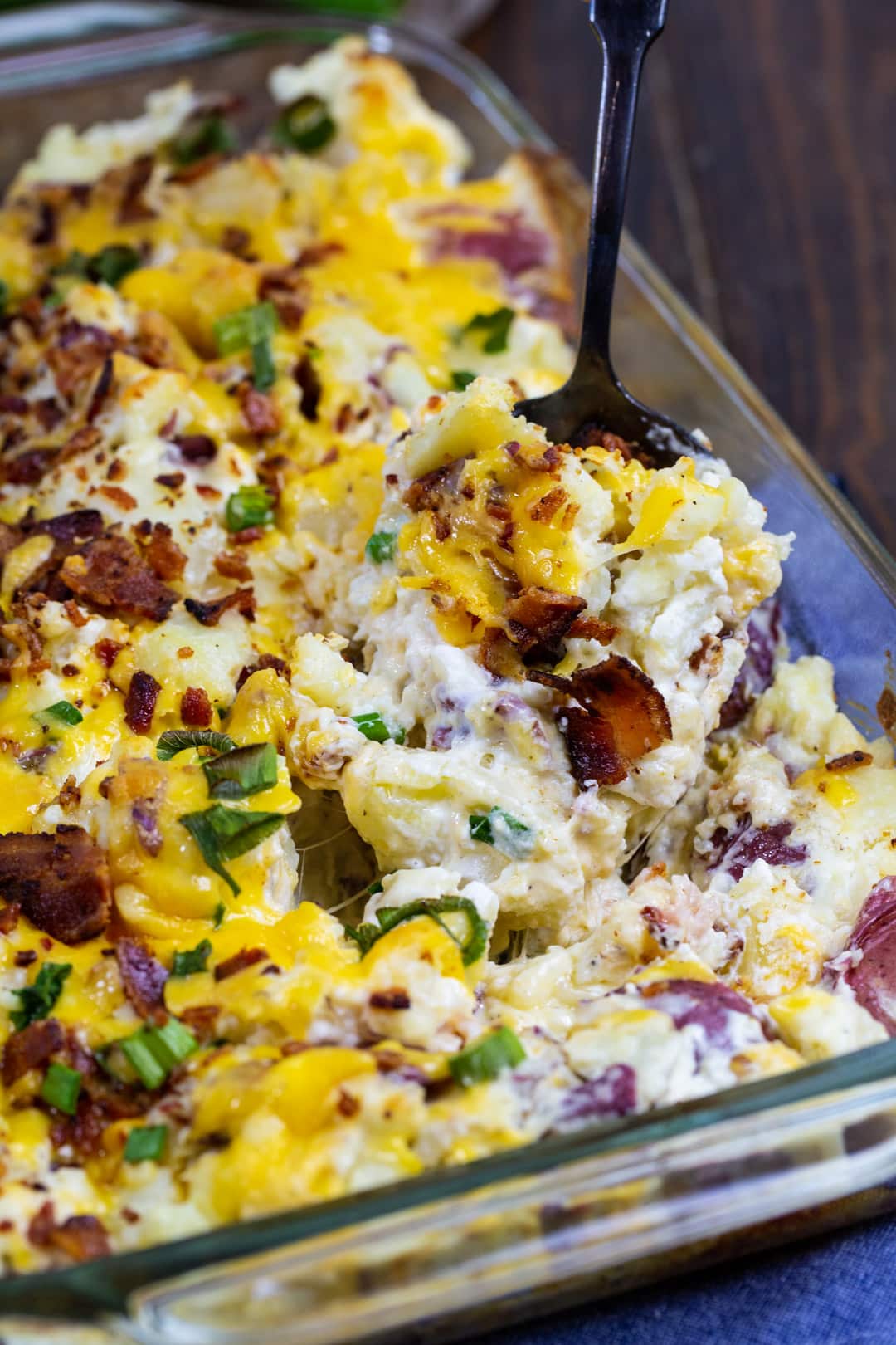 Spoon scooping up Loaded Smashed Potato Casserole.