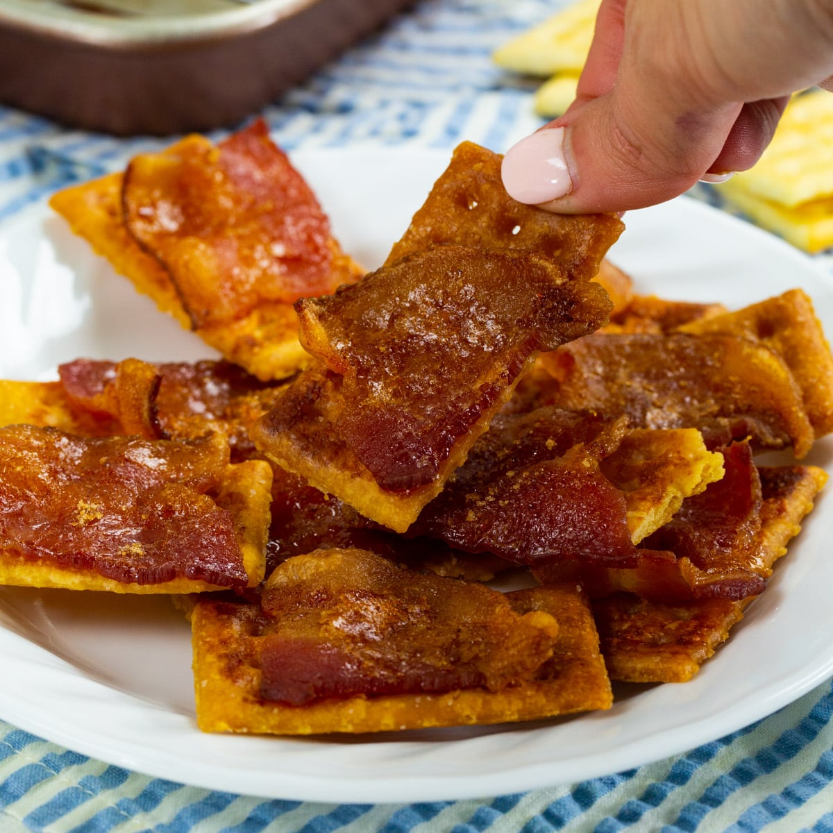 Hand picking up a Bacon Cracker.