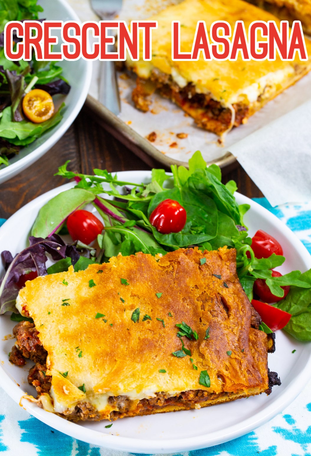 Crescent Lasagna slice on plate with salad.