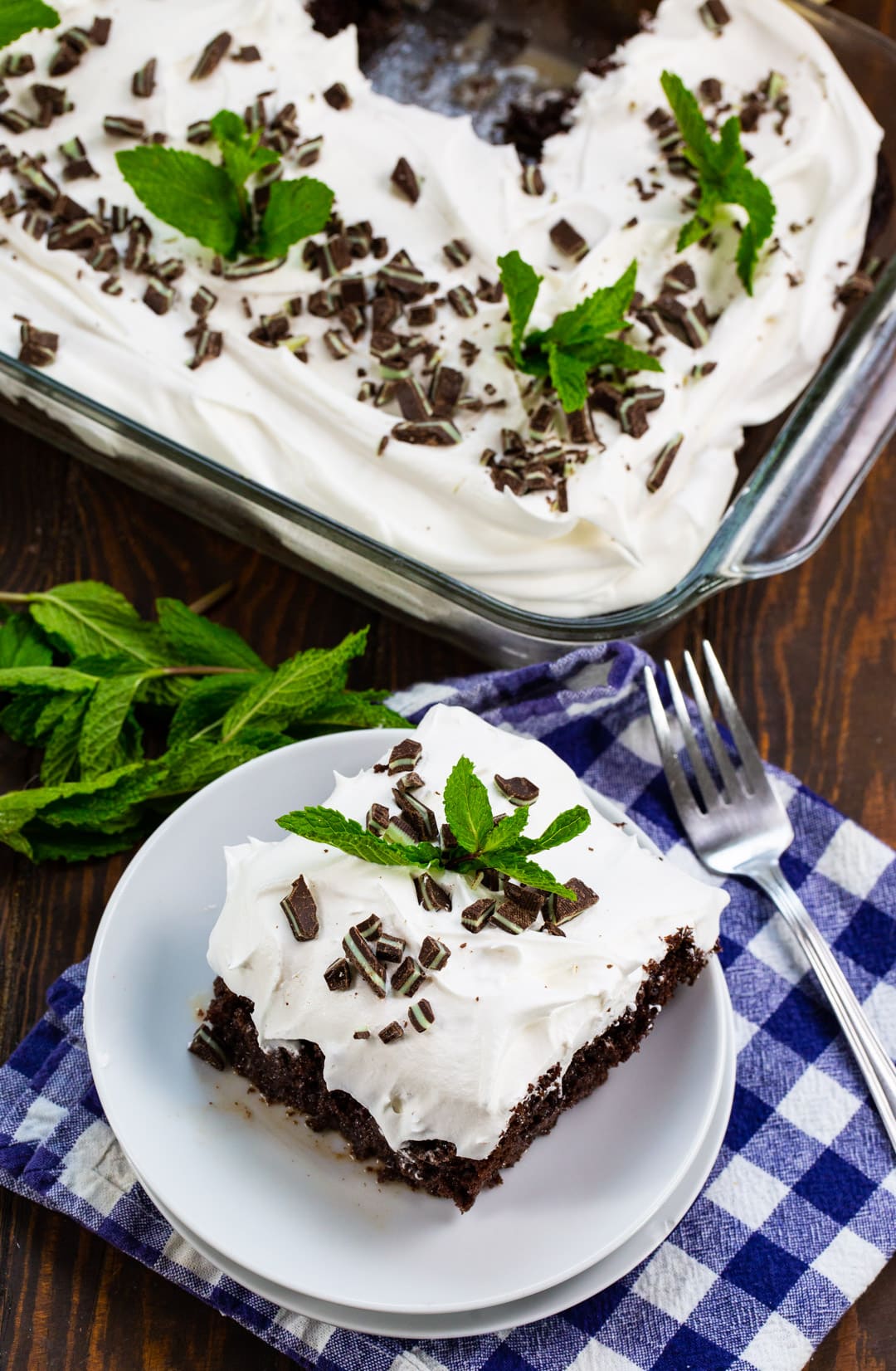 Piece of Poke Cake on a plate and rest of cake in pan.