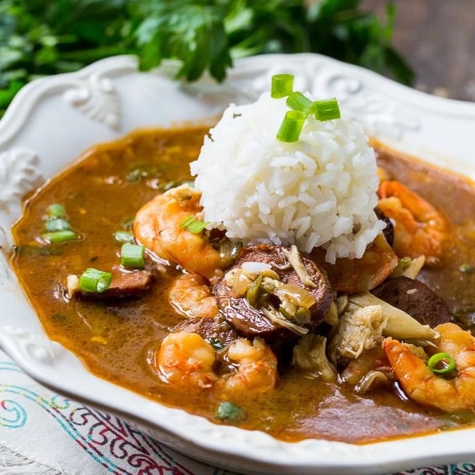 Seafood gumbo topped with white rice.