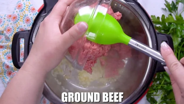 Cooking the ground beef.
