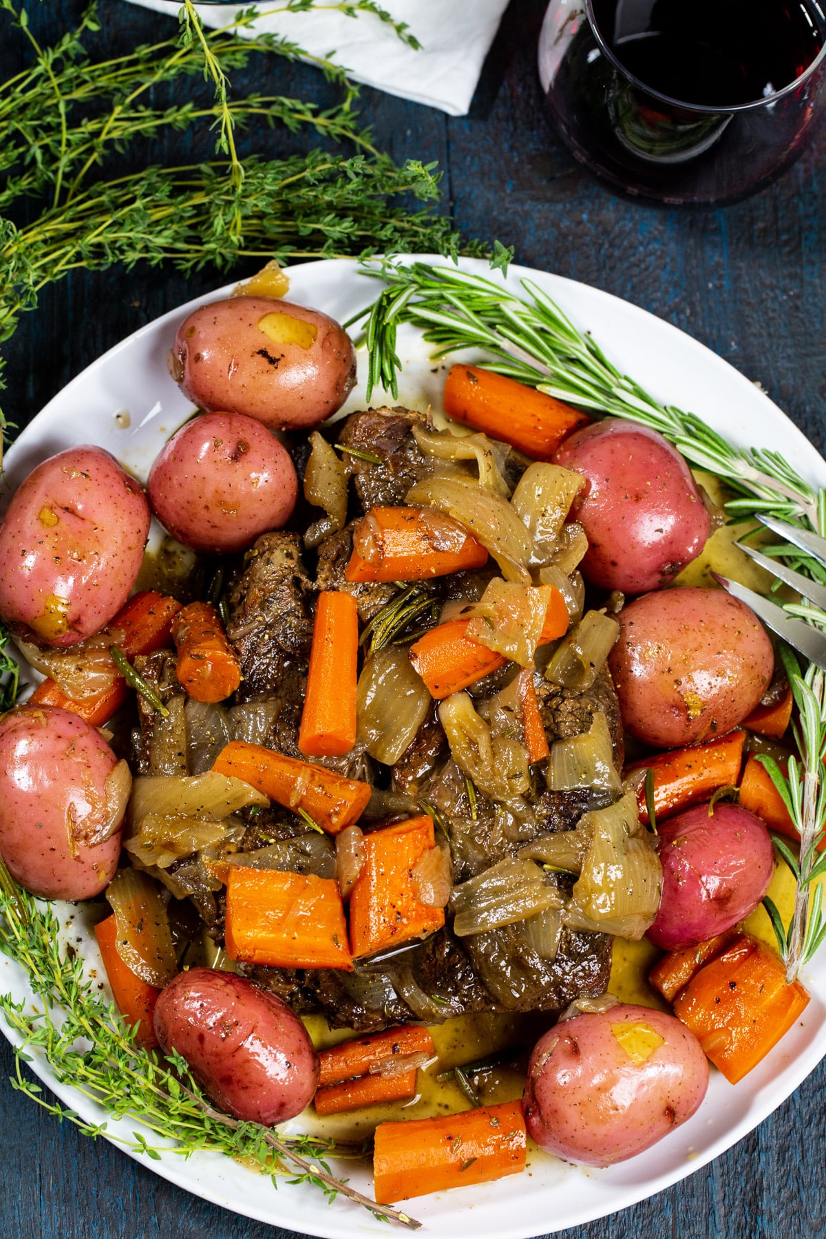 Pot Roast on serving plate with fresh herbs.