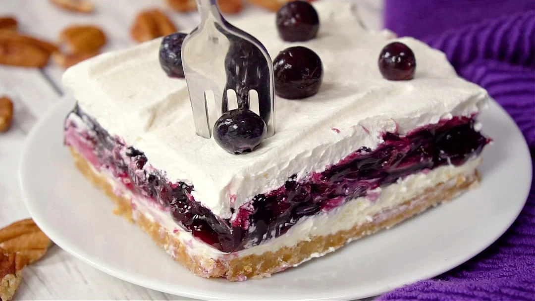 Fork going into piece of blueberry delight.