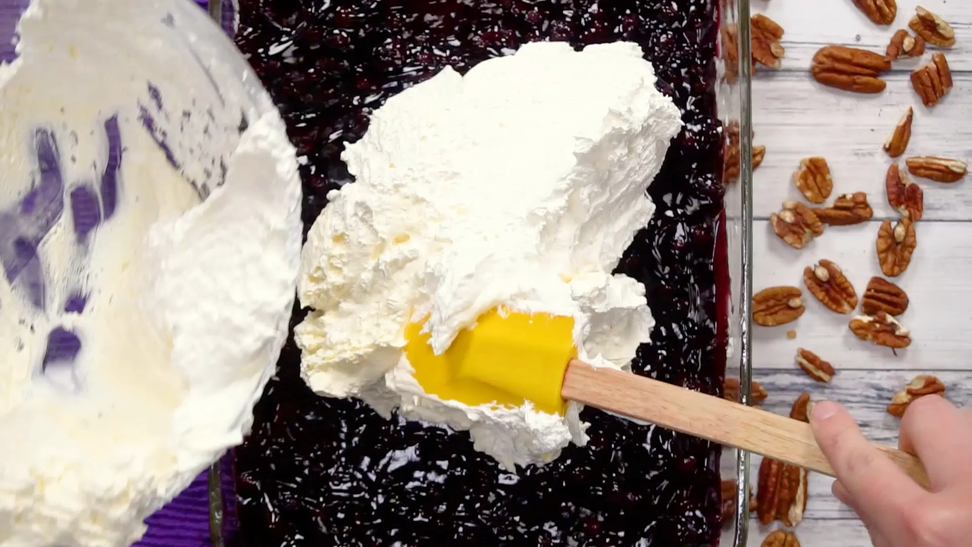 Spreading Cool Whip on top.