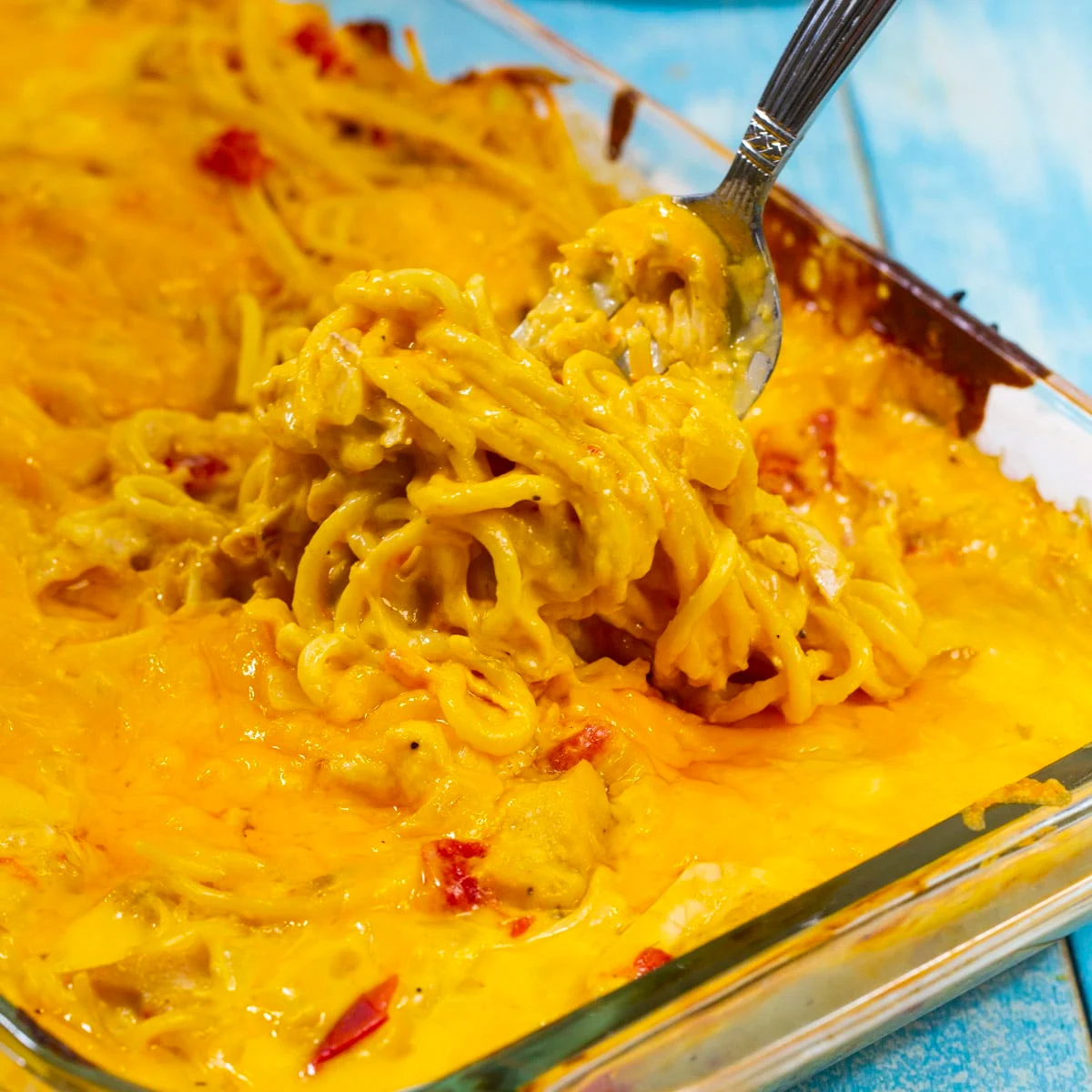 Fork scooping up casserole out of casserole dish.