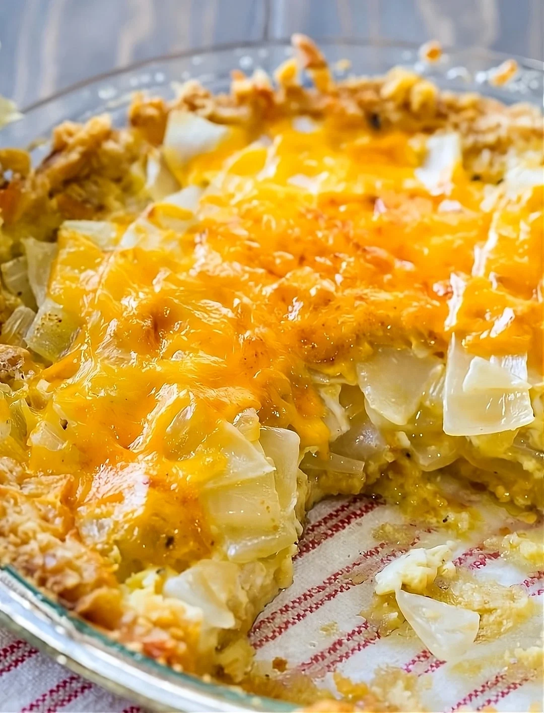 Vidalia Onion Pie in a pie plate with slice cut away.