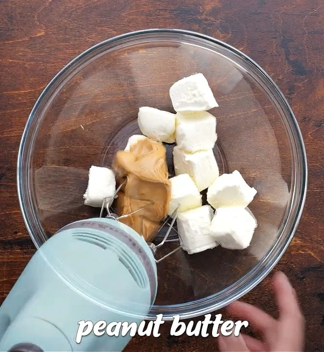 Beating peanut butter and cream cheese until smooth.