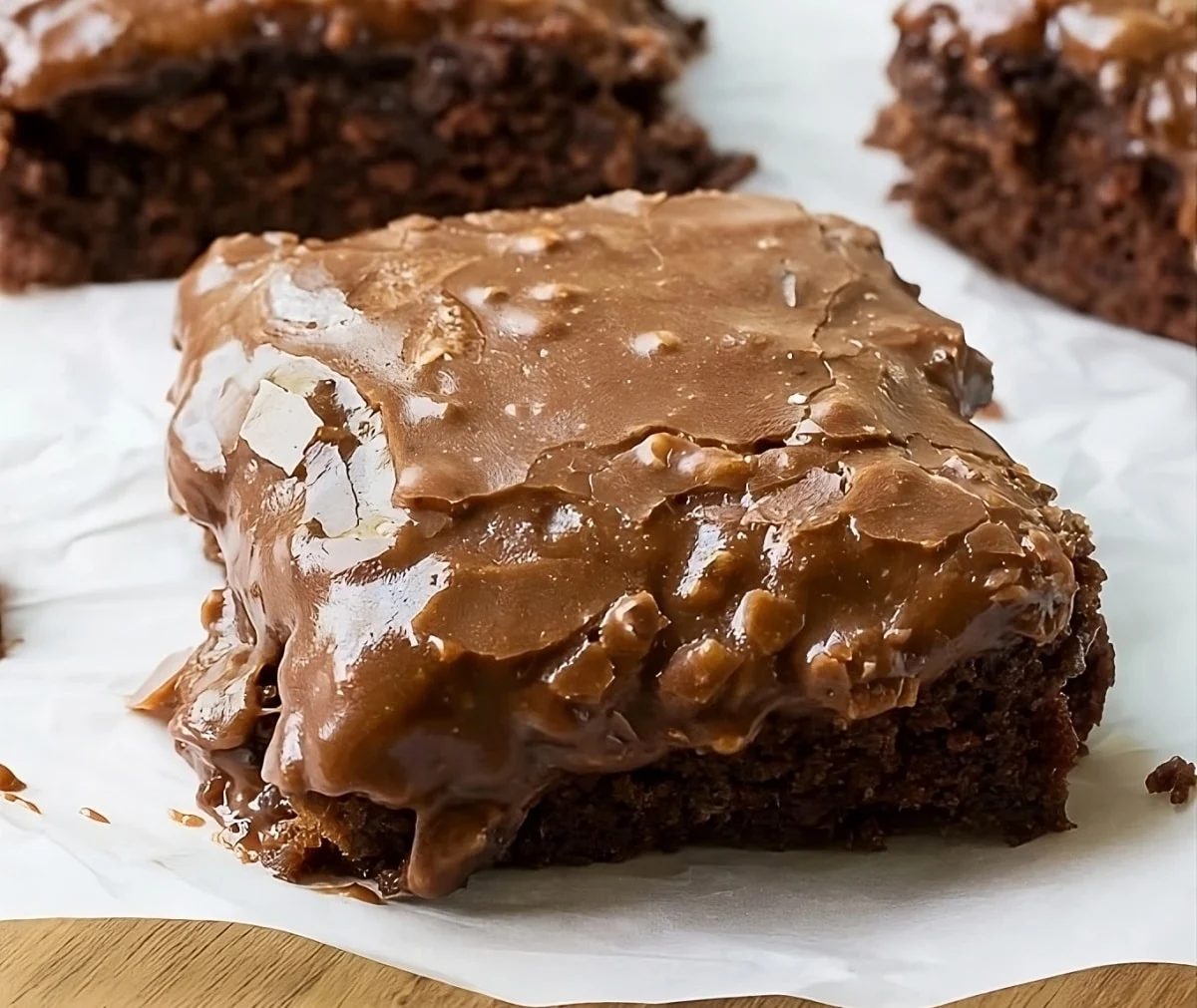 Square of Chocolate Buttermilk Cake on parchment paper.