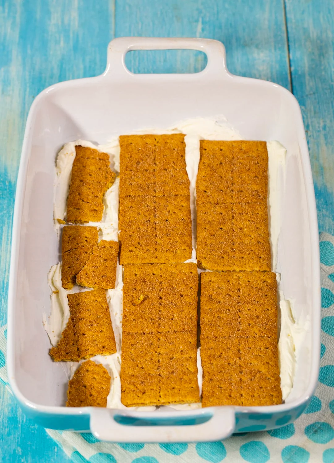 Layer of graham crackers in baking dish.