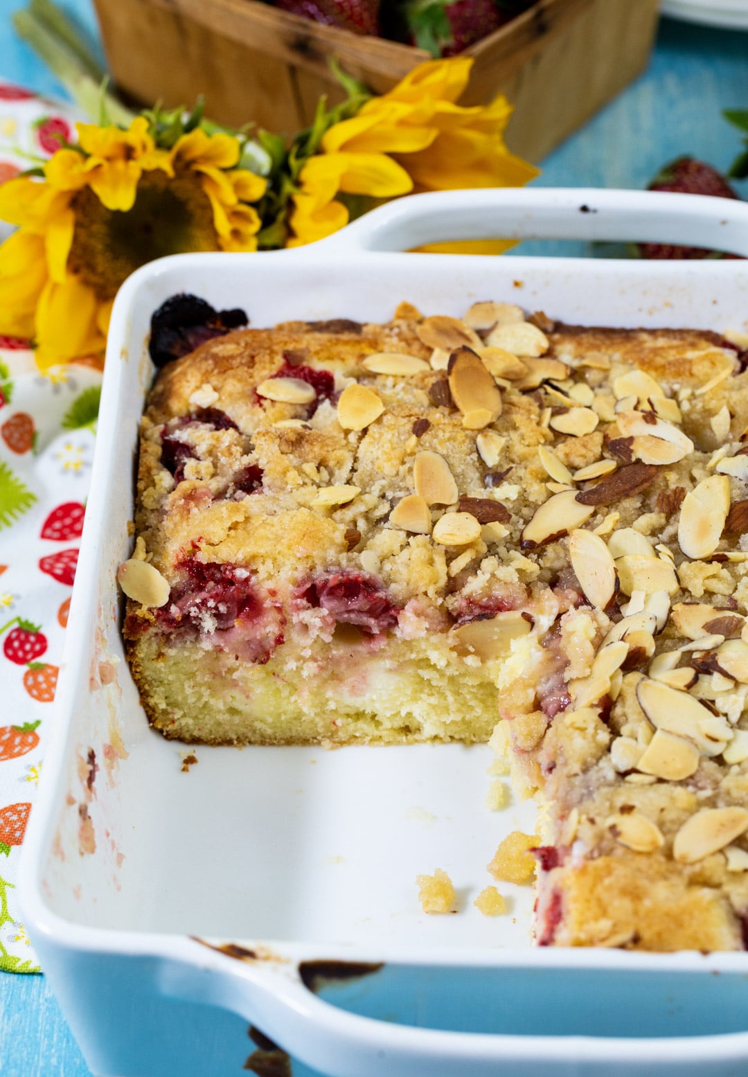 Strawberry Cream Cheese Coffee Cake in baking dish with piece cut away.