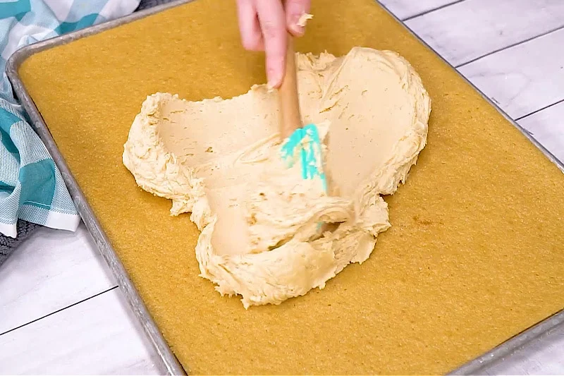 Spreading frosting on cake.