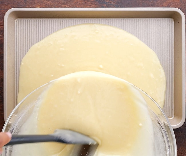 Pouring batter into pan.