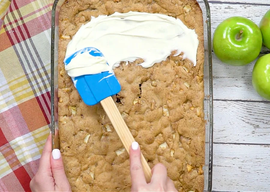 Frosting being spread on cake.
