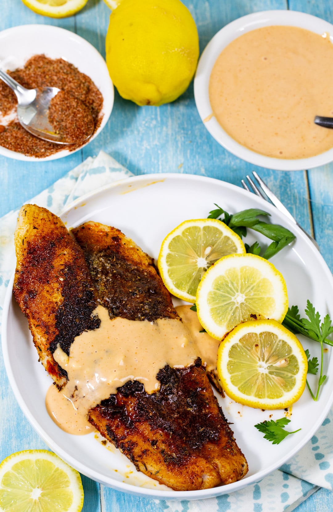 Catfish drizzled with comeback sauce on a plate.