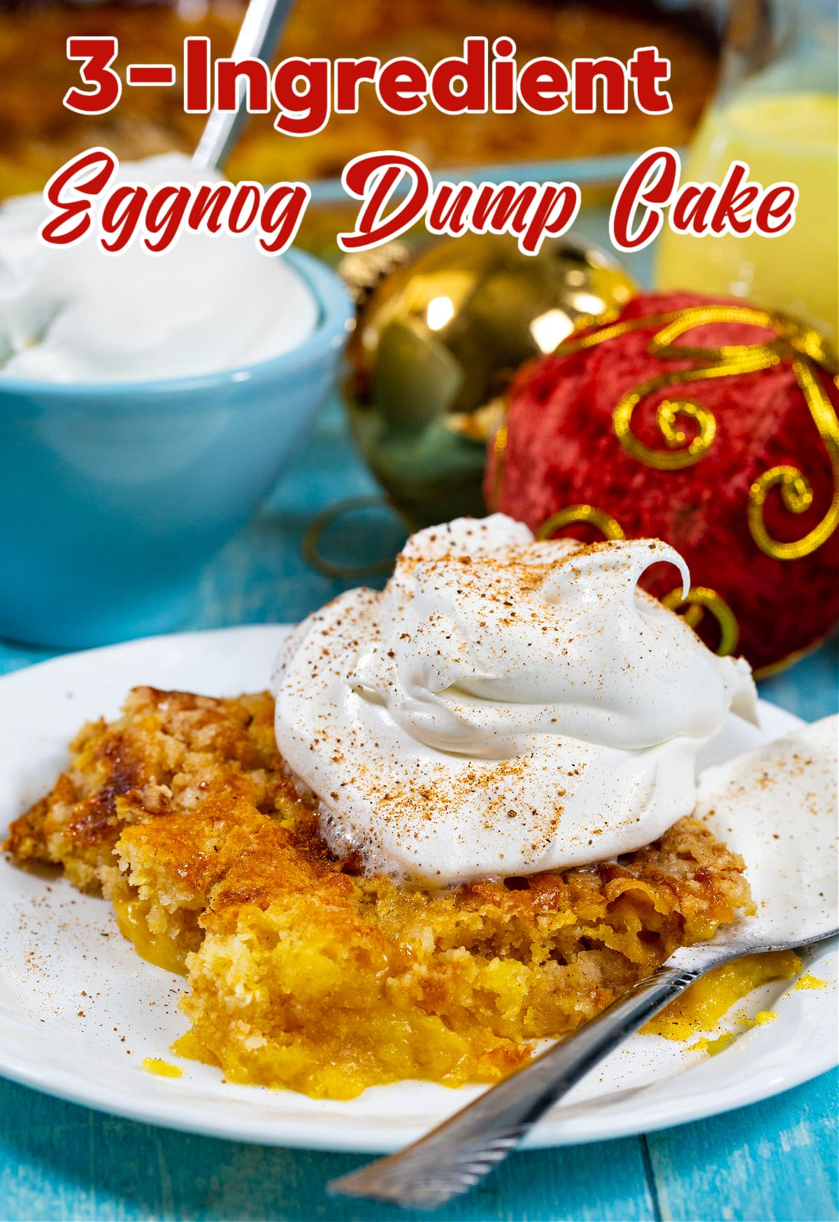 3-Ingredient Eggnog Dump Cake topped with whipped cream.