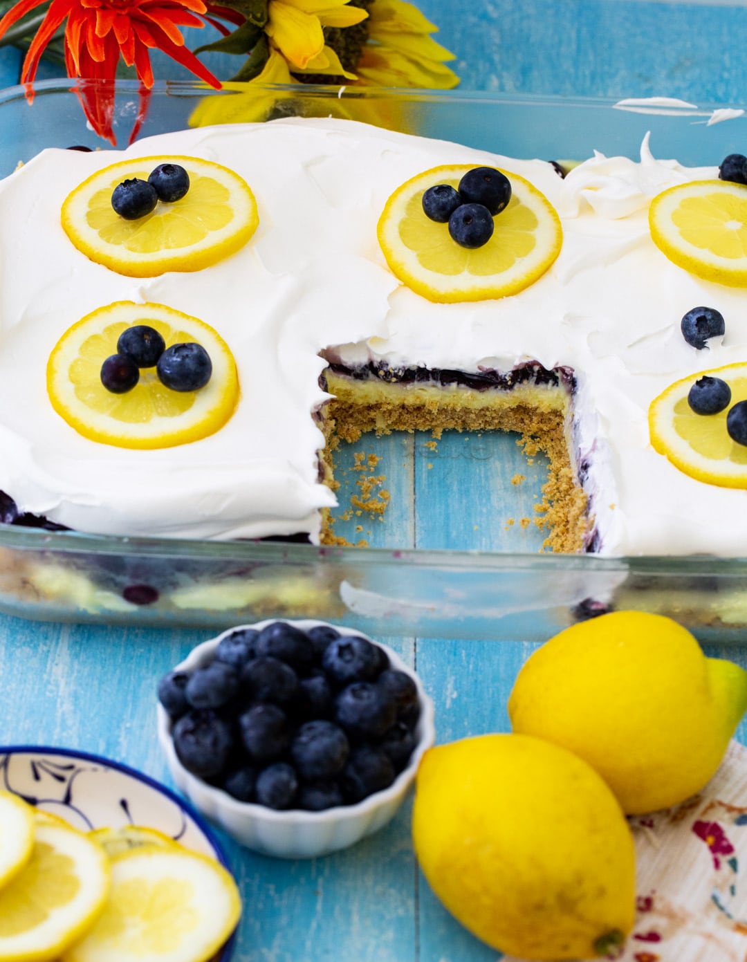 Blueberry Lemon Layer Dessert in baking dish with slice removed.