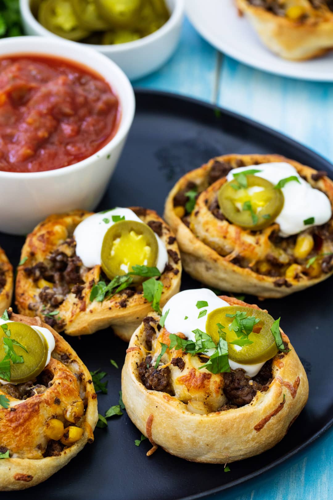 Taco Pizza Rolls topped with sour cream and cilantro.