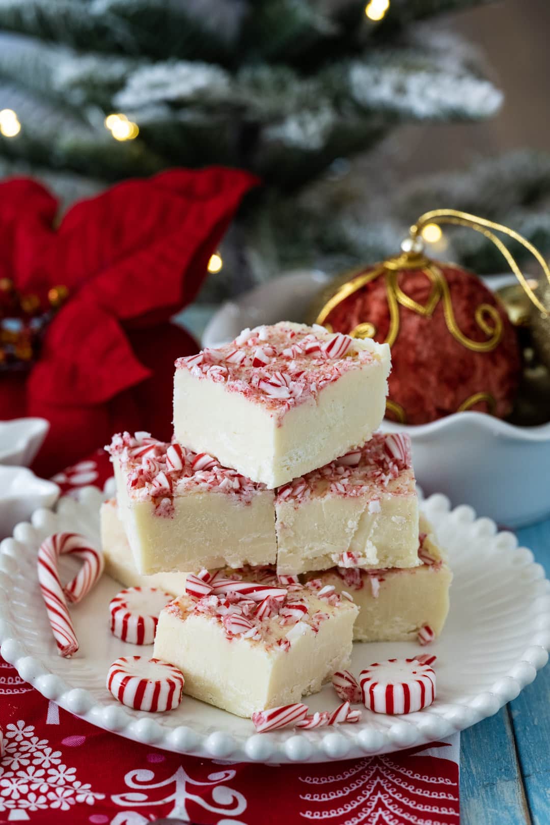Fudge on a plate and Christmas decorations in background.