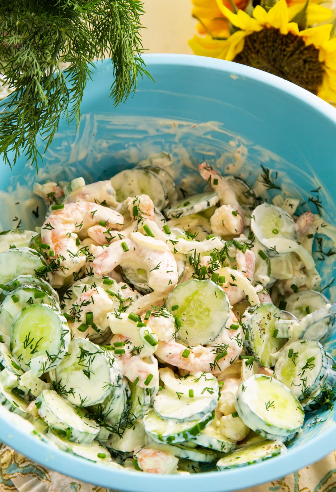 Shrimp salad in a large blue mixing bowl.