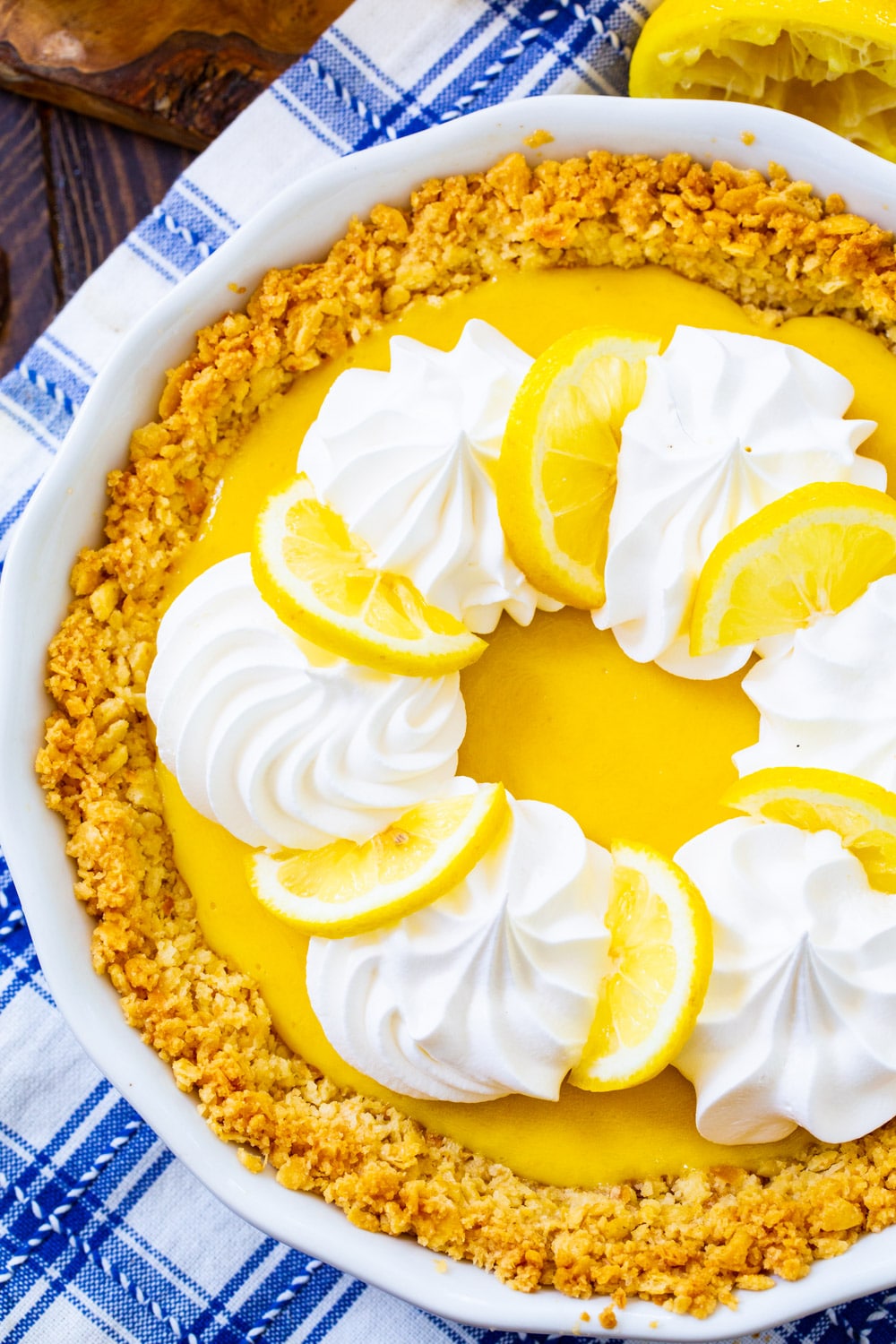 Whole pie topped with whipped cream and lemon slices.