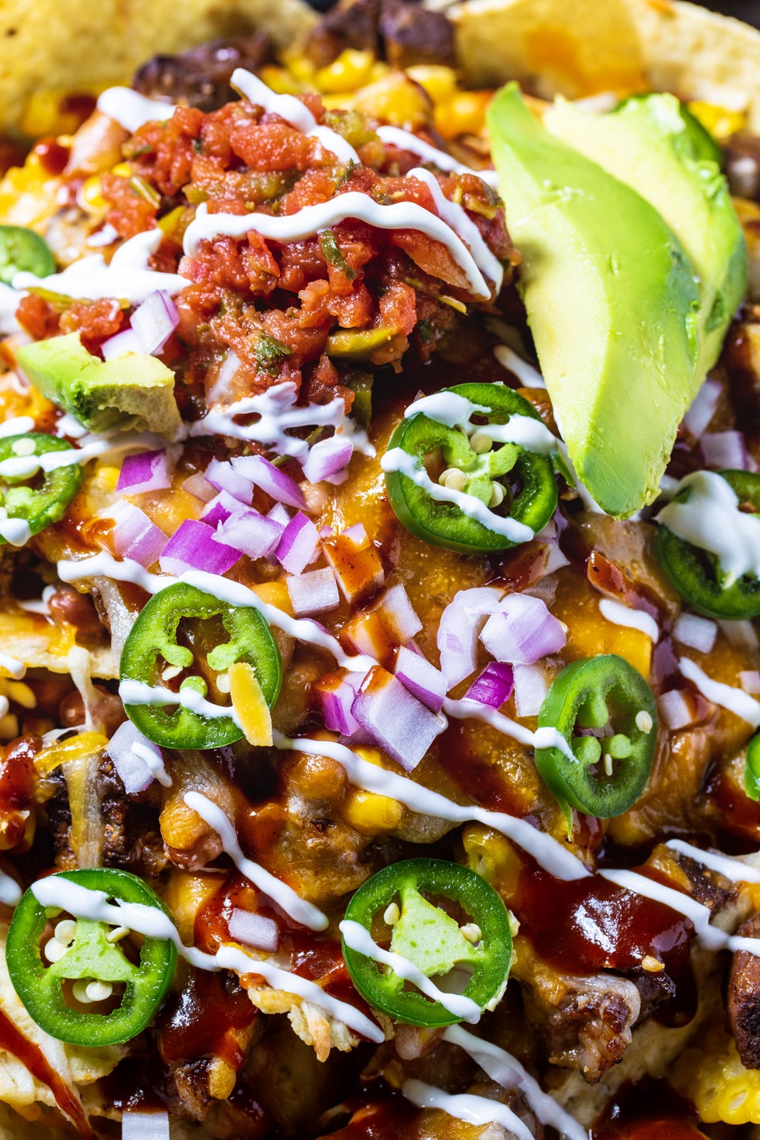 Close-up of Nachos topped with jalapeno slices.