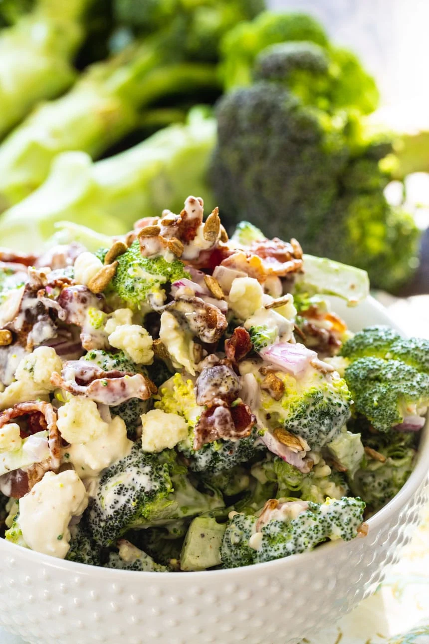 Bacon Broccoli Salad with a bunch of fresh broccoli in background.