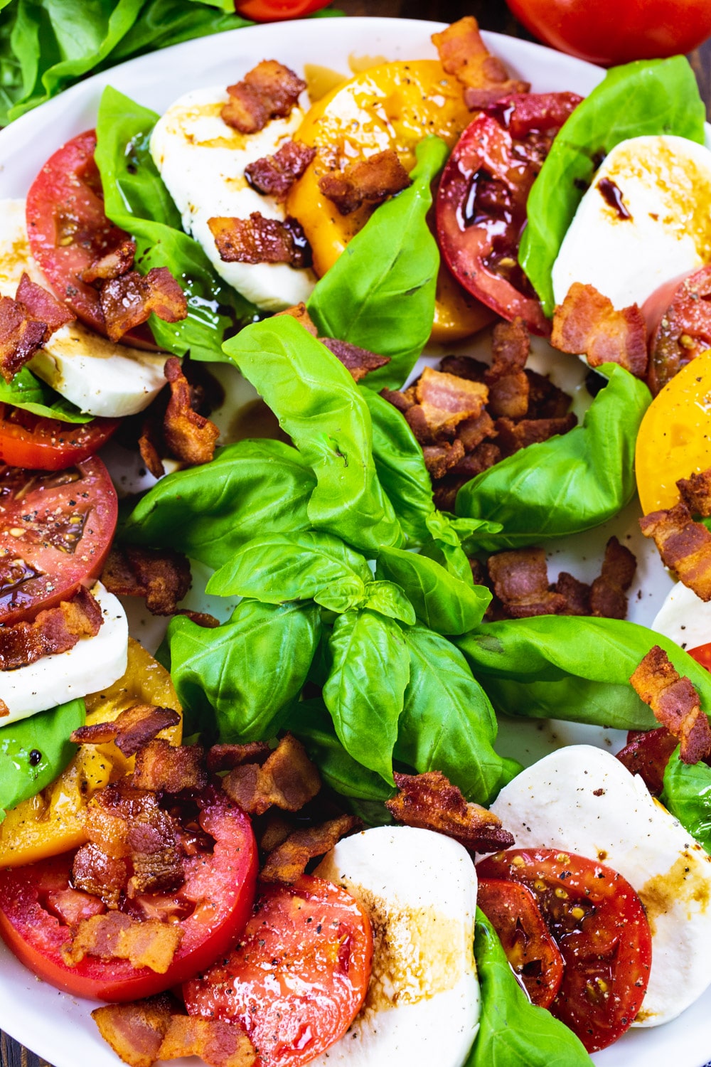 Overhead of Caprese Salad with Bacon on a large serving plate.