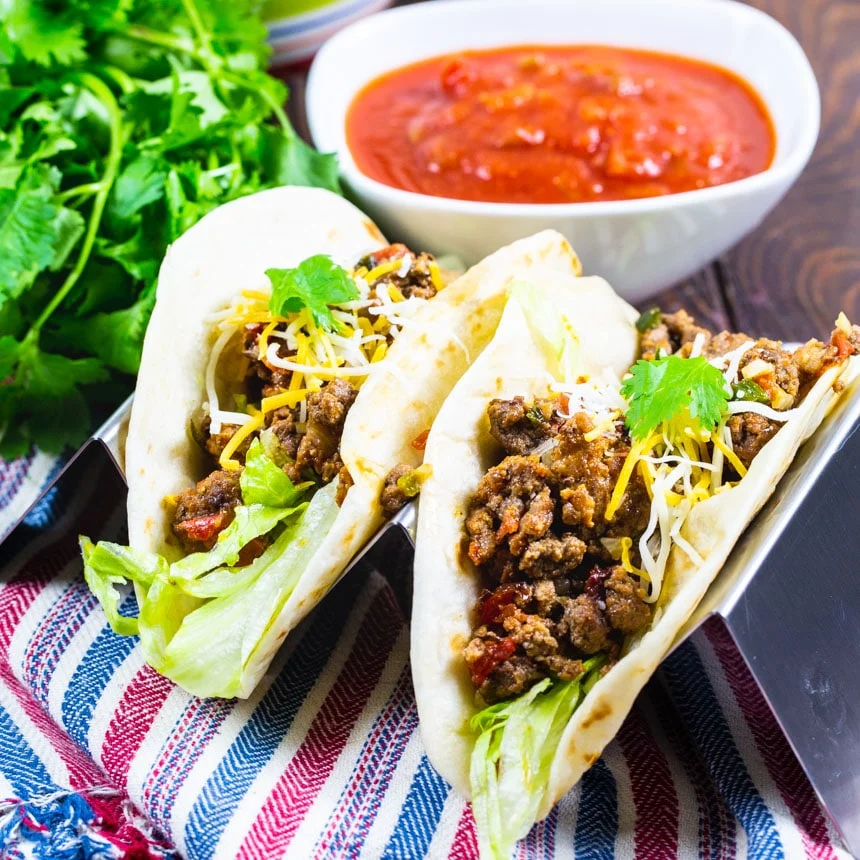 Two tacos in flour tortillas.