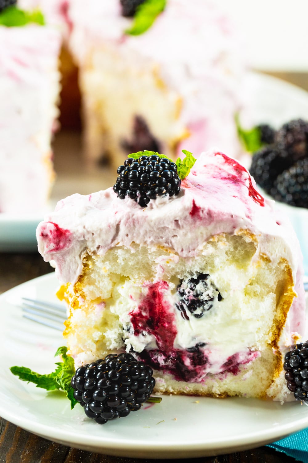 Slice of Blackberries and Cream Angel Food Cake with fresh blackberries.