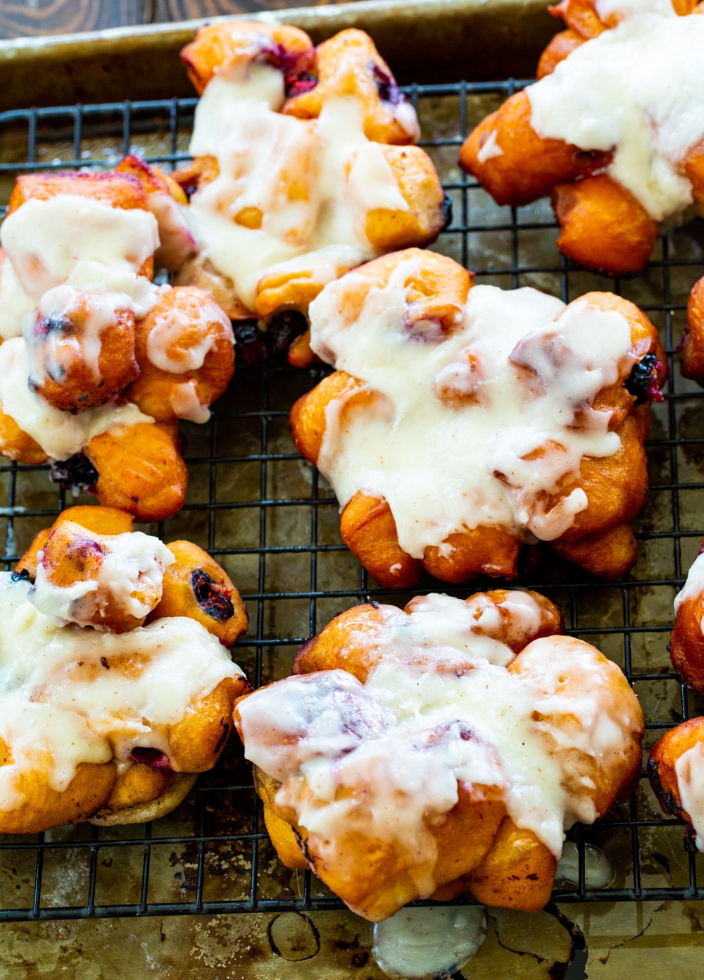 Blueberry Fritters with Browned Butter Glaze on a rack.