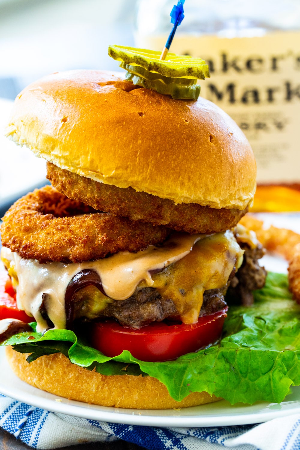Bourbon BBQ Burger on a plate topped with pickle slices.