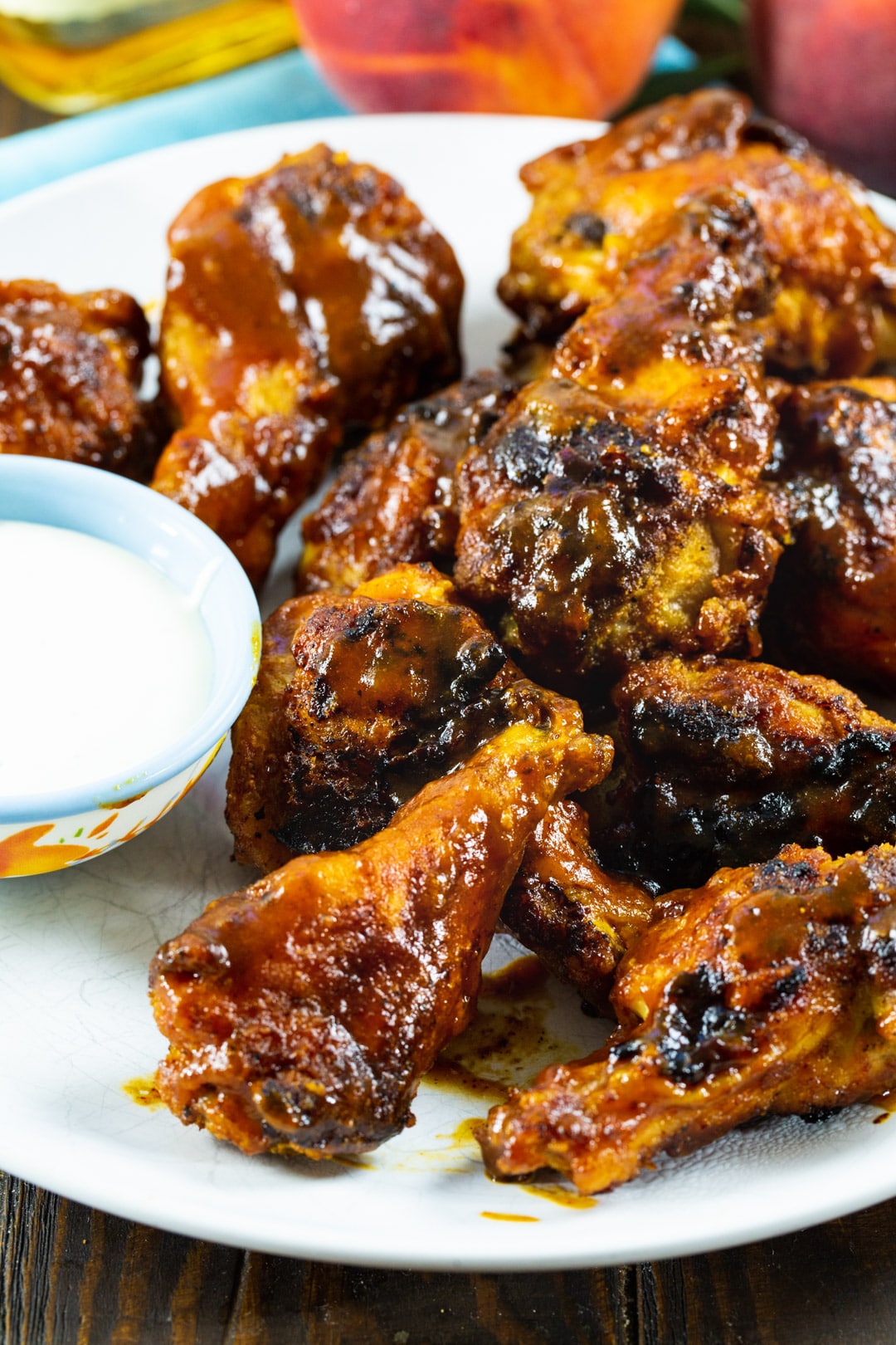 Wings coated with Bourbon Peach BBQ Sauce on a plate.