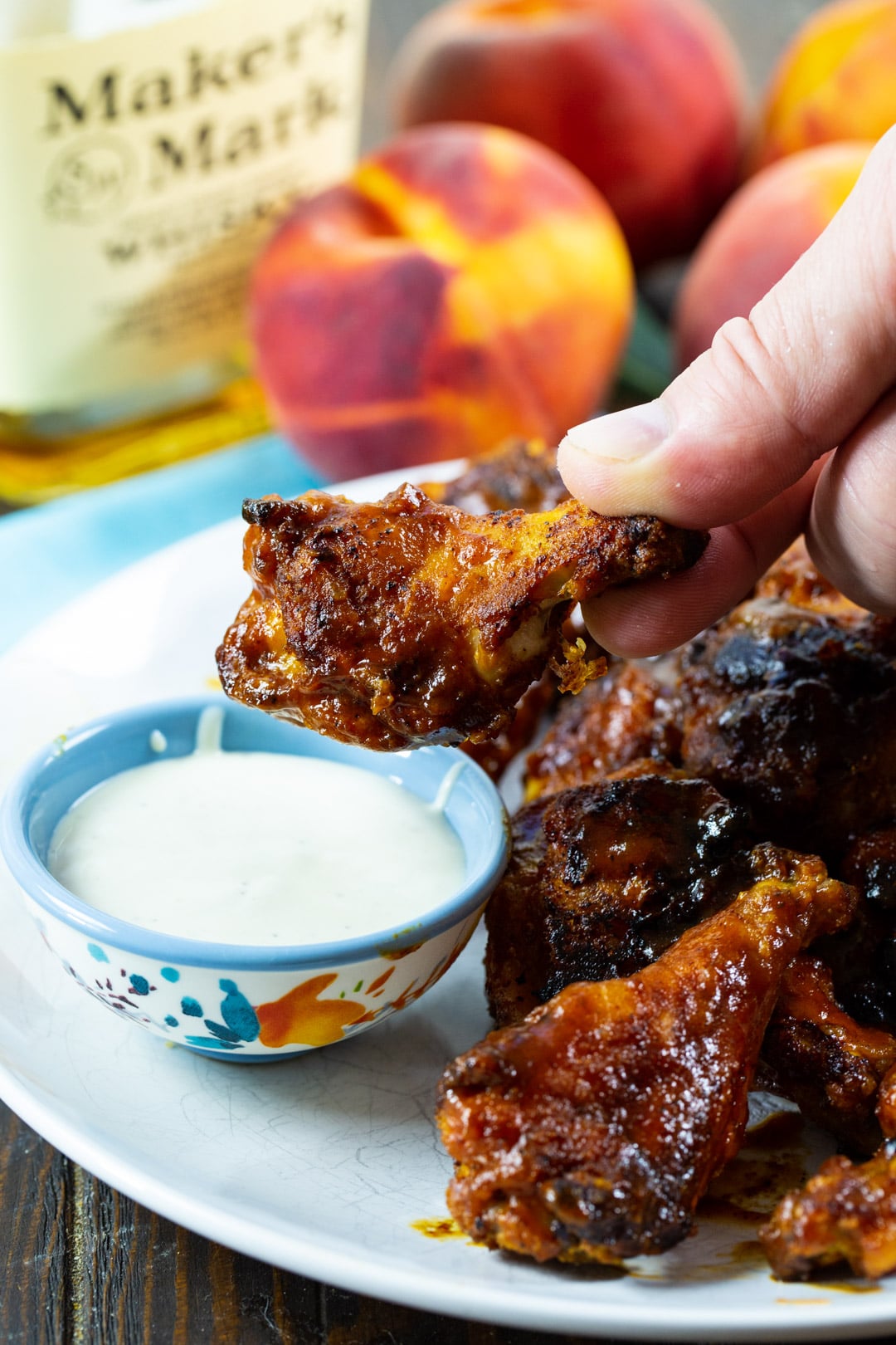 Wing getting dipped in ranch dressing dip.